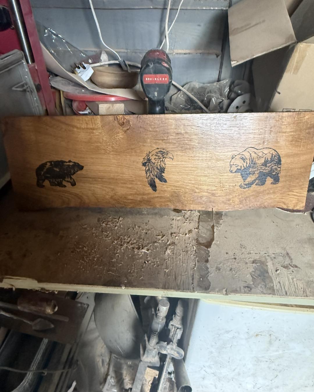 Carved wooden plaque featuring bear and eagle design
